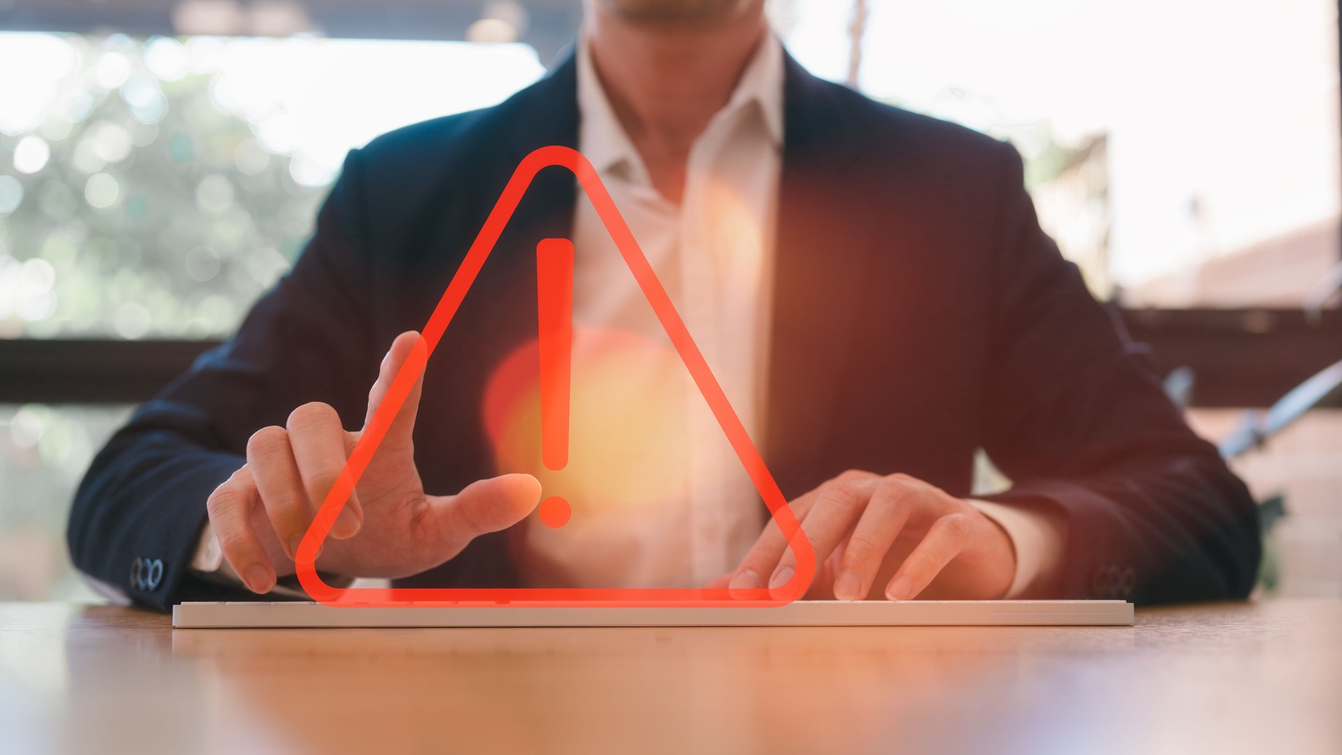 maintenance notification error and risk management concept, protecting data personal information on social network, businessman using computer keyboard and virtual red triangle caution sign